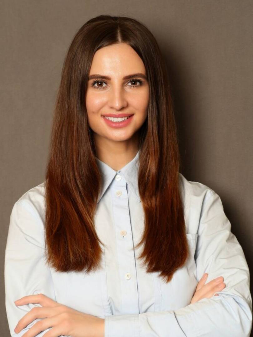 A woman with long hair posing for the camera.