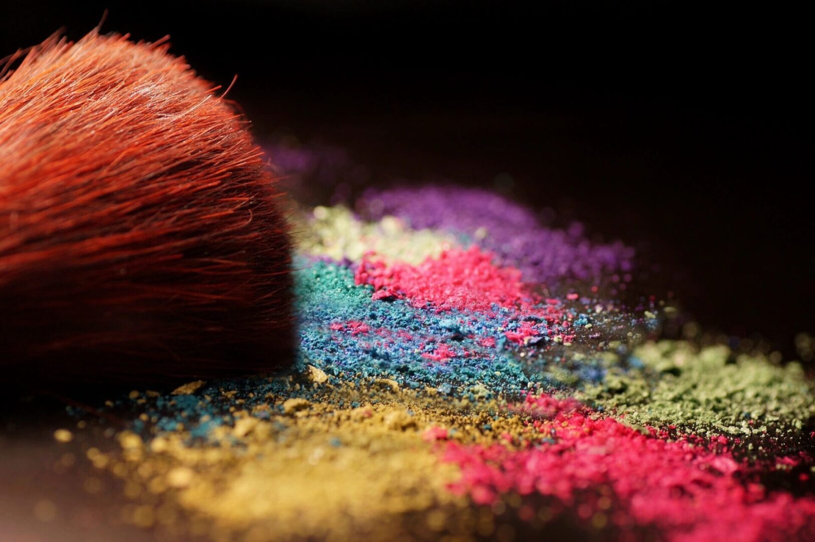 A close up of some colored powder with a brush