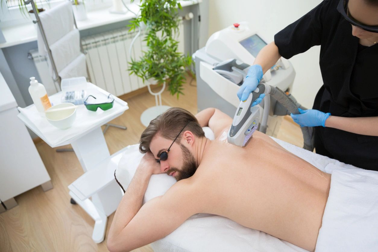 A man getting his back shaved off